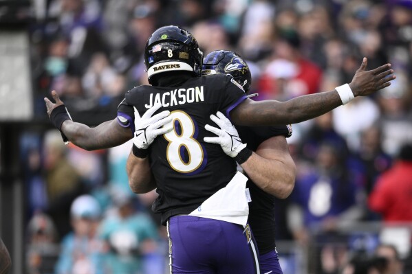 Baltimore Ravens quarterback Lamar Jackson (8) celebrates with Patrick Ricard after their tocudhown against the Miami Dolphins during the second half of an NFL football game in Baltimore, Sunday, Dec. 31, 2023. (AP Photo/Nick Wass)