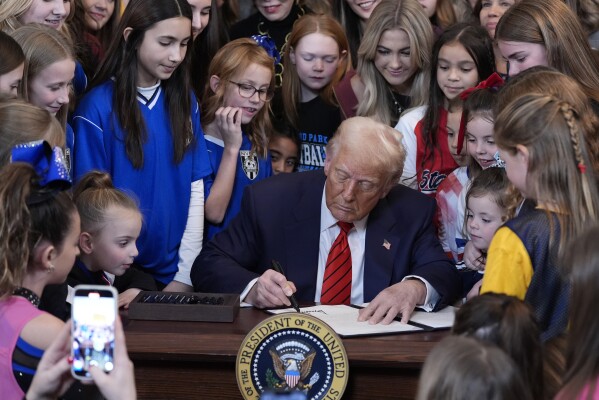 President Donald Trump signs an executive order barring transgender female athletes from competing in women's or girls' sporting events, in the East Room of the White House, in Washington, Feb. 5, 2025. (AP Photo/Alex Brandon, FIle)