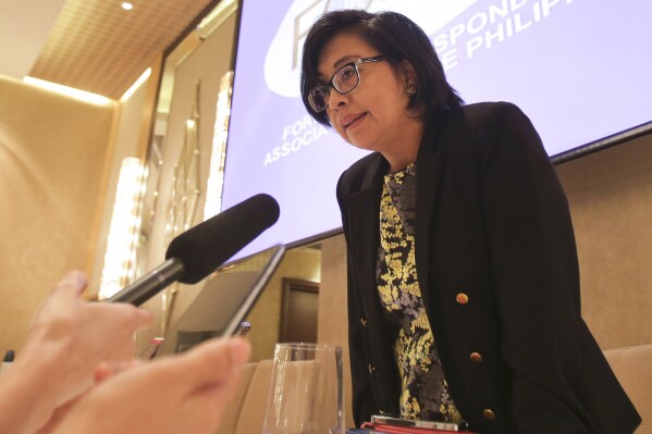 FILE - Miriam Coronel-Ferrer, chief government negotiator in the peace talk with Moro Islamic Liberation Front, answers question from reporters during the Foreign Correspondents Association of the Philippines meeting in Manila, Philippines Wednesday, Feb. 11, 2015. A Philippine university professor who became a peace negotiator and helped ease decades of Muslim insurgency violence in her country and an Indian doctor, who left a major hospital career to treat desperate cancer patients in a far-flung region were among those who won this year's Ramon Magsaysay Awards, regarded as Asia's version of the Nobel Prize. (AP Photo/Aaron Favila, File)