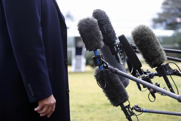 FILE - President Donald Trump stands in front of microphones as he speaks to members of the media on the South Lawn of the White House in Washington, Friday, Feb. 7, 2020, before boarding Marine One. Nearly three-quarters of U.S. adults say the news media is increasing political polarization in this country, and just under half say they have little to no trust in the media's ability to report the news fairly and accurately, according to a new survey from The Associated Press-NORC Center for Public Affairs Research and Robert F. Kennedy Human Rights. (AP Photo/Patrick Semansky, File)