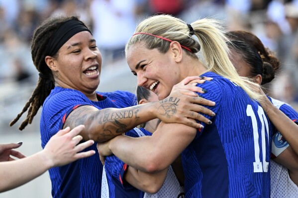 United States midfielder Lindsey Horan (10) celebrates with forward Mia Fishel, left, and other teammates after scoring against Colombia during the second half of an international friendly soccer match Sunday, Oct. 29, 2023, in San Diego. (AP Photo/Alex Gallardo)