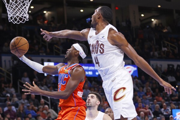 Oklahoma City Thunder guard Shai Gilgeous-Alexander, left, prepares to shoot in front of Cleveland Cavaliers forward Evan Mobley (4) during the second half of an NBA basketball game, Wednesday, Nov. 8, 2023, in Oklahoma City. (AP Photo/Nate Billings)