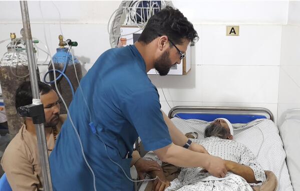 A wounded man receives treatment in a hospital, after a bombing at a mosque in the town of Imam Saheb, in Kunduz Province in north of Kabul, Afghanistan, Friday, April 22, 2022. A Taliban official says a bombing at a mosque and religious school in northern Afghanistan on Friday killed at least 33 people, including students of a religious school. (AP Photo/Abdullah Sahil)