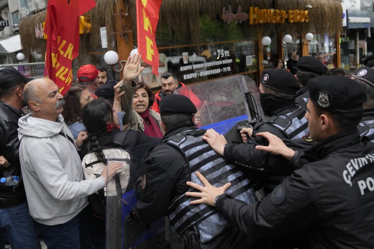 Union  clash with Turkish police officers as they march during Labor Day celebrations in Istanbul, Turkey, Wednesday, May 1, 2024. Police in Istanbul detained dozens of people who tried to reach the city's main square, Taksim, in defiance of a government ban on Labor Day celebrations on 1 From May at the historic site.  (AP Photo/Khalil Hamra)