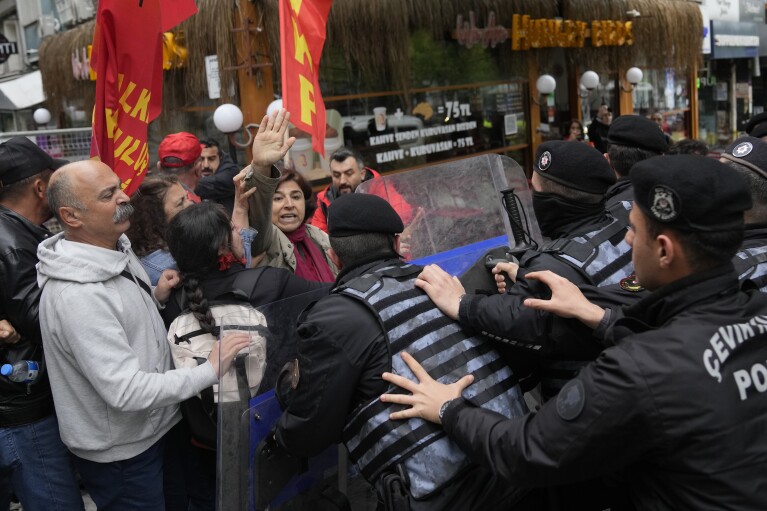 Union members scuffle with Turkish police officers as they march during Labor Day celebrations in Istanbul, Turkey, Wednesday, May 1, 2024. Police in Istanbul detained dozens of people who tried to reach the city's main square, Taksim, in defiance of a government ban on celebrating May 1 Labor Day at the landmark location. (AP Photo/Khalil Hamra)