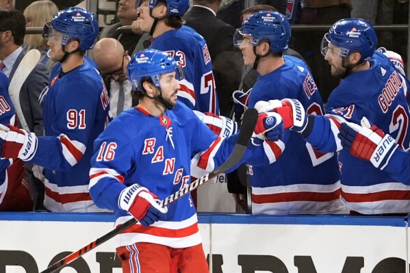 New York Rangers' Vincent Trocheck (16) celebrates with teammates after scoring a goal during the first period in Game 2 of an NHL hockey Stanley Cup first-round playoff series against the Washington Capitals, Tuesday, April 23, 2024, in New York. (AP Photo/Frank Franklin II)