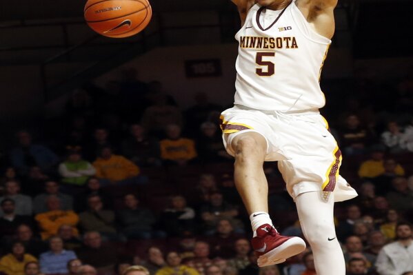 
              FILE - In this Jan. 23, 2018, file photo, Minnesota's Amir Coffey dunks against Northwestern during the second half of an NCAA college basketball game, in Minneapolis. Coming off an injury-ravaged season with a 15-17 record, Minnesota is primed for a bounce back in coach Richard Pitino's sixth year. (AP Photo/Jim Mone, File)
            