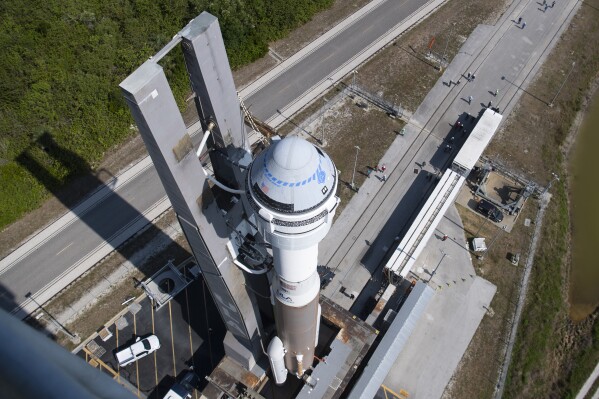 FILE - A United Launch Alliance Atlas V rocket with Boeing's CST-100 Starliner spacecraft is rolled out of the Vertical Integration Facility, May 18, 2022 at Cape Canaveral Space Force Station in Florida. Boeing’s first Starliner flight with astronauts aboard has been delayed until at least next March. (Joel Kowsky/NASA via AP, File)