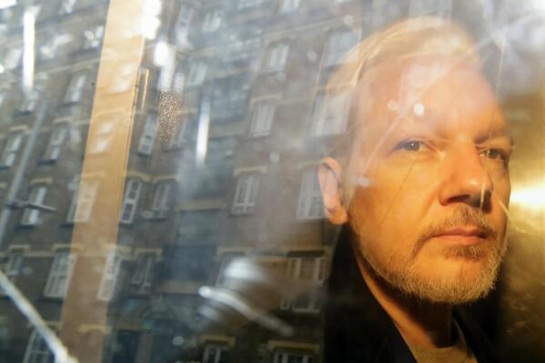 FILE - Buildings are reflected in the window as WikiLeaks founder Julian Assange is taken from court, where he appeared on charges of jumping British bail seven years ago, in London, Wednesday May 1, 2019. Assange has appealed against the British's government decision last month to order his extradition to the U.S. The appeal was filed Friday, July 1, 2022 at the High Court, the latest twist in a decade-long legal saga sparked by his website's publication of classified U.S. documents. (AP Photo/Matt Dunham, File)