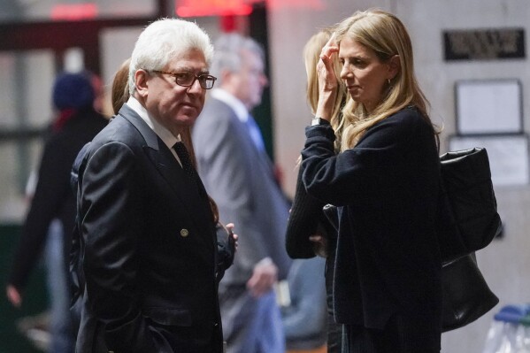 Rare-book dealer Glenn Horowitz, left, is seen in the supreme court hall way during a break in proceedings, Wednesday, Feb. 21, 2024, in New York. A criminal case involving handwritten lyrics to the classic rock megahit “Hotel California” and other Eagles favorites went to trial Wednesday in New York, with three men accused of scheming to thwart band co-founder Don Henley’s efforts to reclaim the allegedly ill-gotten documents. (AP Photo/Mary Altaffer)