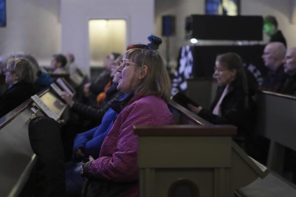 People sing as they attend an AI-created service at St. Paul's Lutheran church in Helsinki, Finland, Tuesday, March 4, 2025.