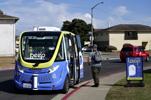 A driverless shuttle stops for a passenger on San Francisco's Treasure Island as part of a pilot program to assess the safety and effectiveness of autonomous vehicles for public transit on Aug. 16, 2023. The free bus service was launched less than a week after California regulators approved the controversial expansion of robotaxis on city streets. (AP Photo/Terry Chea)