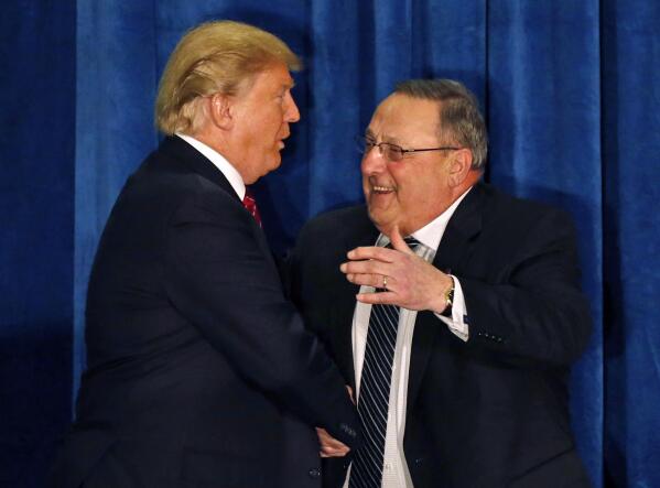 FILE - Republican presidential candidate Donald Trump is welcomed to the stage by Maine Gov. Paul LePage at campaign stop in Portland, Maine, in this March 3, 2016 file photo. LePage, who moved to Florida after his second term, has returned to Maine to challenge Democratic Gov. Janet Mills. (AP Photo/Robert F. Bukaty)