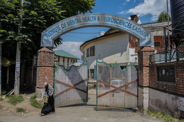 A Kashmiri patient walks out from a mental health hospital in Srinagar, Indian controlled Kashmir, Wednesday, Aug 2, 2023. Kashmir's mental healthcare clinics depict invisible scars of decades of violent armed insurrections, brutal counterinsurgency, unparalleled militarization, unfulfilled demands for self-determination have fueled depression and drugs in the disputed region, experts say. (AP Photo/Mukhtar Khan)