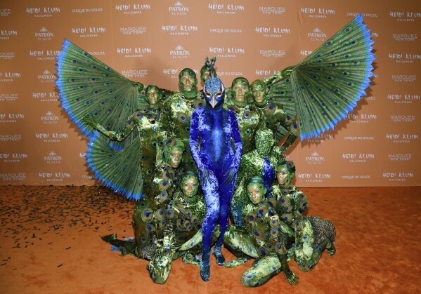 Heidi Klum, center, in blue, arrives at her 22nd annual Halloween party at Marquee on Tuesday, Oct. 31, 2023, in New York. (Photo by Evan Agostini/Invision/AP)