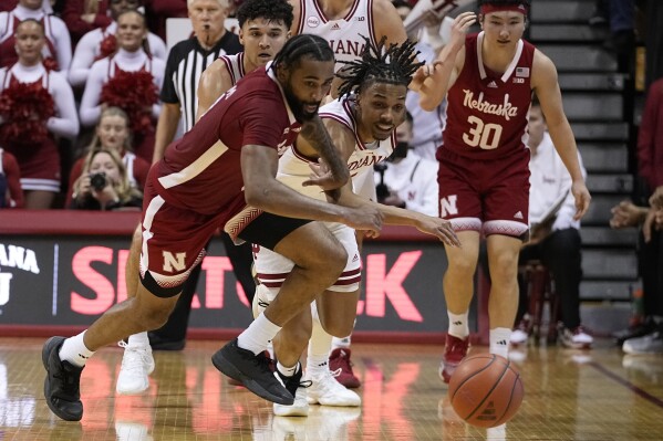 Nebraska guard Brice Williams (3) and Indiana guard CJ Gunn (11) go for a loose ball during the second half of an NCAA college basketball game, Wednesday, Feb. 21, 2024, in Bloomington, Ind. (AP Photo/Darron Cummings)