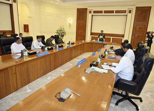 In this image provided by The Myanmar Military True News Information Team, Myanmar's military leader Senior Gen. Min Aung Hlaing, center, speaks during meeting with members of the National Defense and Security Council Friday, Jan. 31, 2025, in Naypyitaw, Myanmar.(The Myanmar Military True News Information Team via AP)