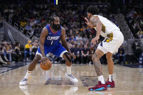 Los Angeles Clippers guard James Harden (1) drives on Indiana Pacers forward Obi Toppin (1) during the second half of an NBA basketball game in Indianapolis, Monday, Dec. 18, 2023. (AP Photo/Michael Conroy)