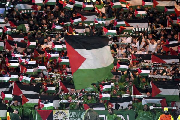 Celtic fans in the stands wave Palestinian flags ahead of the Champions League Group E match between Celtic Glasgow and Atletico Madrid, at Celtic Park, in Glasgow, Scotland, Wednesday, Oct. 25, 2023. (Andrew Milligan/PA via AP)