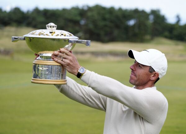 Northern Ireland's Rory McIlroy lifts the trophy following day four of the Genesis Scottish Open 2023 golf tournament at The Renaissance Club, North Berwick, Britain, Sunday, July 16, 2023. (Jane Barlow/PA via AP)