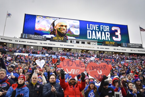 FILE - Fans stand in support for Buffalo Bills safety Damar Hamlin before an NFL football game against the New England Patriots, Jan. 8, 2023, in Orchard Park, N.Y. Damar Hamlin plans to support young people through education and sports with the $8.6 million in GoFundMe donations that unexpectedly poured into his toy drive fundraiser after he suffered a cardiac arrest in the middle of a game. GoFundMe crowdfunding campaigns have generated $30 billion since 2010, the fundraising platform announced Tuesday, Feb. 6, 2024. (AP Photo/Adrian Kraus, File)