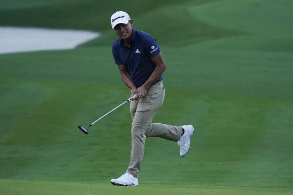 Collin Morikawa reacts to his putt on the second hole during the first round of play in The Players Championship golf tournament Thursday, March 10, 2022, in Ponte Vedra Beach, Fla. (AP Photo/Lynne Sladky)