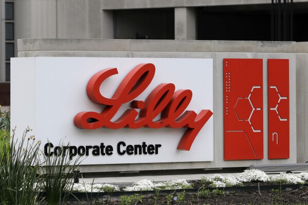 FILE - A sign for Eli Lilly & Co. sits outside their corporate headquarters in Indianapolis on April 26, 2017. Eli Lilly will spend more than $5 billion to expand an Indiana manufacturing site and eventually make more doses of its hot-selling weight-loss and diabetes treatments, Zepbound and Mounjaro. The drugmaker said Friday, May 24, 2024 that it was more than doubling its investment in a site near its Indianapolis headquarters. (AP Photo/Darron Cummings, File)