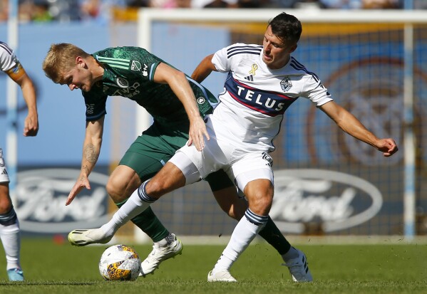 Gauld's late PK goal helps Whitecaps tie Sporting KC 1-1