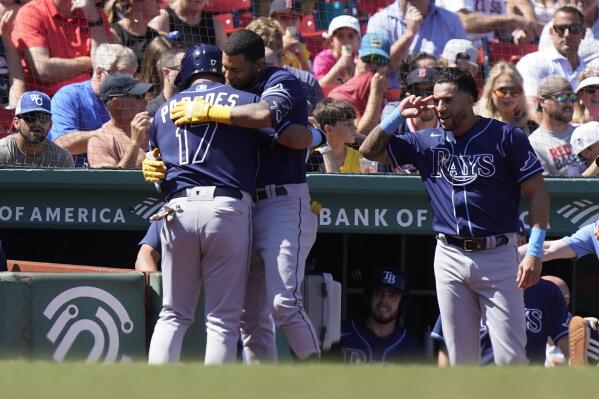 Tampa Bay Rays' Isaac Paredes, left, celebrates with Jose Siri, center, as he is welcomed to the dugout after hitting a home run in the second inning of a baseball game against the Boston Red Sox, Sunday, Aug. 28, 2022, in Boston. (AP Photo/Steven Senne)
