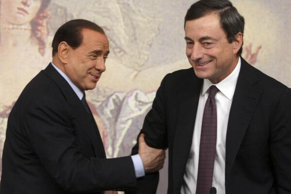 FILE - Former and present Italian Premiers Silvio Berlusconi, left, and Mario Draghi, right, are seen during a press conference at Chigi Palace,in Rome, on Oct. 8, 2008. Italy’s lower chamber of parliament on Tuesday set Jan. 24 as the start date to begin voting for a new Italian president, officially kicking off a campaign that is expected to see Premier Mario Draghi and ex-Premier Silvio Berlusconi vie for the prestigious job. The victor, who is chosen by around 1,000 “big electors" among lawmakers and regional representatives, will replace President Sergio Mattarella, whose seven-year term ends Feb. 3. The voting is expected to last several rounds over several days. (AP Photo/Sandro Pace)
