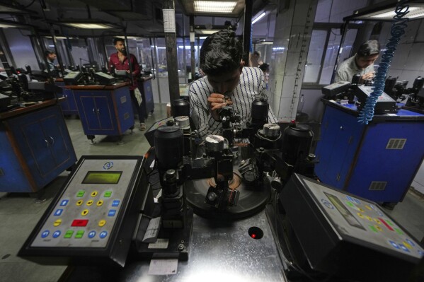 An employee works at a diamond cutting and processing workshop in Surat, India, on April 14, 2025. (AP Photo/Ajit Solanki)