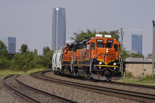 FILE - A BNSF locomotive heads south out of Oklahoma City, Wednesday, Sept. 14, 2022. A fifth rail union has approved its deal with the freight railroads to secure 24% raises and $5,000 in bonuses and a sixth one is set to vote Thursday. But all 12 rail unions must ratify their contracts to prevent a strike. (AP Photo/Sue Ogrocki, File)