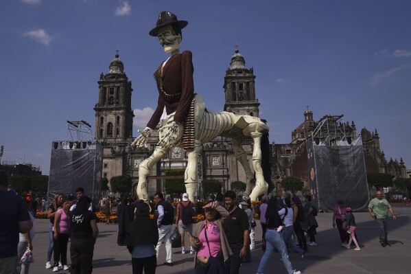 A catrina sculpture in the likeness of Mexican revolutionary Hero Pancho Villa stands at the Zocalo, Mexico City´s main square, during celebrations ahead of the Day of the Dead on Tuesday, Oct. 31, 2023. (AP Photo/Marco Ugarte)