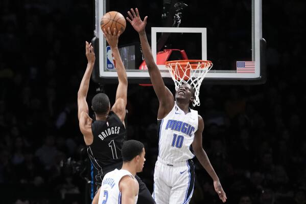 Brooklyn Nets forward Mikal Bridges (1) goes to the basket against Orlando Magic center Bol Bol (10) during the first half of an NBA basketball game Friday, April 7, 2023, in New York. (AP Photo/Mary Altaffer)