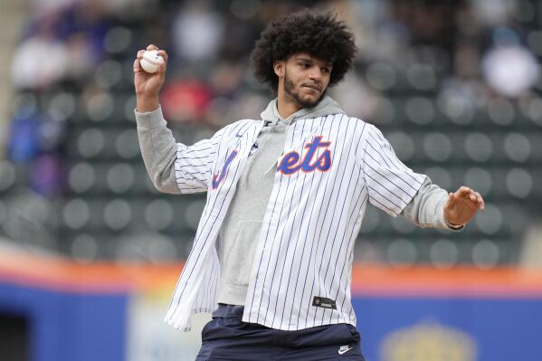 Andre Jackson Jr., a starter on the University of Connecticut's NCAA college championship basketball team, throws out the first pitch before a doubleheader between the New York Mets and the Atlanta Braves at Citi Field, Monday, May 1, 2023, in New York. (AP Photo/Seth Wenig)