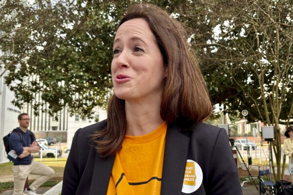 Corinn O'Brien, 37, who became pregnant through IVF, stands near the capitol in Montgomery, Ala., during a rally on Feb. 28, 2024. An ultrasound recently showed the fetus might be in trouble, and she wants the option to try again if she needs to. (AP Photo/Kim Chandler)