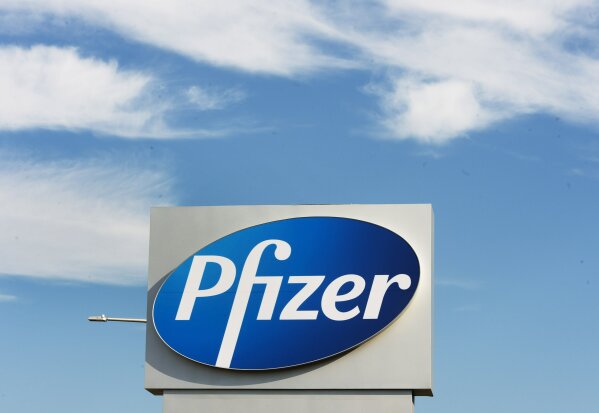 FILE - In this Monday, Nov. 9, 2020, file photo, a sign with the Pfizer logo stands outside the corporate headquarters of Pfizer Canada in Montreal. Pfizer and BioNTech say they've won permission Wednesday, Dec. 2, 2020, for emergency use of their COVID-19 vaccine in Britain, the world’s first coronavirus shot that’s backed by rigorous science -- and a major step toward eventually ending the pandemic. (Ryan Remiorz/The Canadian Press via AP, File)