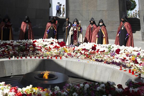 Armenian Apostolic Church leader Catholicos Garegin II, center, attends a memorial service at the monument to the victims of mass killings by Ottoman Turks, to commemorate the 106th anniversary of the massacre, in Yerevan, Armenia, Saturday, April 24, 2021. Armenians marked the anniversary of the death of up to 1.5 million Armenians by Ottoman Turks, an event widely viewed by scholars as genocide, though Turkey refutes the claim. (Grigor Yepremyan/PAN Photo via AP)