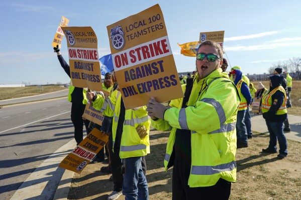 Teamsters protest at Cincinnati/Northern Kentucky International Airport near the DHL Express Hub Friday, Dec. 8, 2023, in Erlanger Ky. More than 1,000 union members at DHL walked off the job at Cincinnati/Northern Kentucky International Airport, a critical logistics hub for the package delivery company, during the busiest time of the year. The Teamsters say they are protesting unfair labor practices at the DHL Express hub. (AP Photo/Carolyn Kaster)