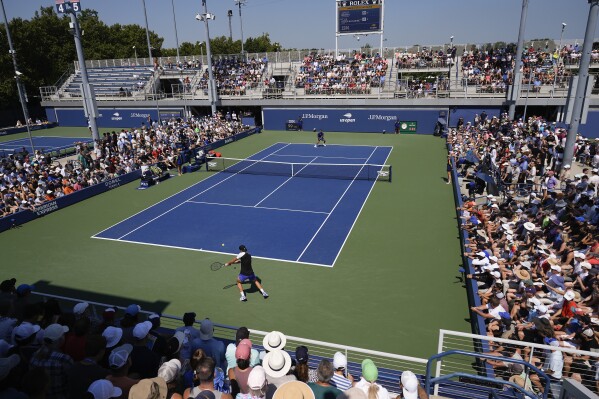 Jakub Mensik, of the Czech Republic, returns a shot to Felix Auger-Aliassime, of Canada, during the first round of the U.S. Open tennis championships, Tuesday, Aug. 27, 2024, in New York. (AP Photo/Pamela Smith)