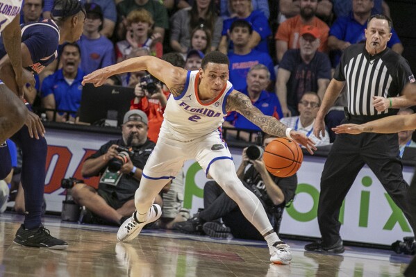 Florida guard Riley Kugel (2) grabs the loose ball during the first half of an NCAA college basketball game against Auburn Saturday, Feb. 10, 2024, in Gainesville, Fla. (AP Photo/Alan Youngblood)