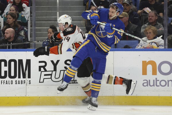 Buffalo Sabres left wing Zemgus Girgensons (28) and Anaheim Ducks left wing Ross Johnston (44) collide during the second period of an NHL hockey game Monday, Feb. 19, 2024, in Buffalo, N.Y. (AP Photo/Jeffrey T. Barnes)