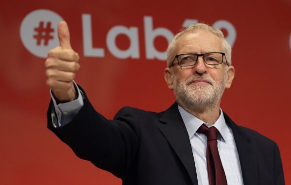 Jeremy Corbyn, leader of Britain's opposition Labour Party gives a thumbs up as a reaction to the news from Britain's Supreme Court, on stage during the Labour Party Conference at the Brighton Centre in Brighton, England, Tuesday, Sept. 24, 2019. The Supreme Court has ruled that Britain's Prime Minister Boris Johnson's suspension of Parliament was unlawful. (AP Photo/Kirsty Wigglesworth)