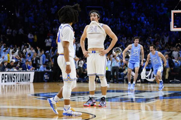UCLA's Tyger Campbell, left, and Jaime Jaquez Jr. react after UCLA lost a college basketball game against North Carolina in the Sweet 16 round of the NCAA tournament, Friday, March 25, 2022, in Philadelphia. (AP Photo/Chris Szagola)