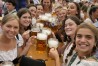 FILE - Women with glasses of beer pose for a photo on day one of the 188th 'Oktoberfest' beer festival in Munich, Germany, Saturday, Sept. 16, 2023. The southern German state of Bavaria will ban the smoking of cannabis at public festivals, inside beer gardens, and even at the world’s most popular beer festival, the Oktoberfest. (AP Photo/Matthias Schrader, File)