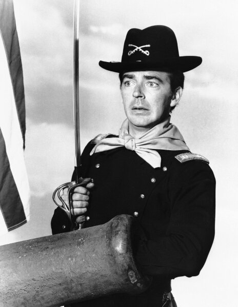 
              FILE - In a  July 1, 1965 file photo, Ken Berry, who plays Captain Wilton Parmenter in a TV series called "F Troop," reaches down the wrong end of cannon in one of the show's episodes. A spokeswoman at Providence St. Joseph in Burbank, Calif., confirmed Berry died Saturday, Dec. 1, 2018. He was 85. (AP Photo, File)
            