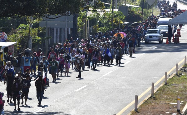 Migrants walk along a highway in Huixtla, Mexico, Monday, Dec. 25, 2023. A caravan of migrants set out north through southern Mexico just days before U.S. Secretary of State Antony Blinken arrives in Mexico City to discuss new agreements to control the surge of migrants seeking entry into the United States. (AP Photo/Edgar H. Clemente)