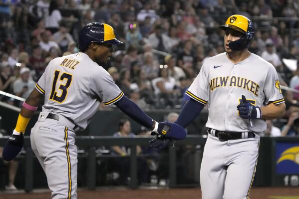 Milwaukee Brewers' Tyrone Taylor celebrates with Esteury Ruiz (13) after scoring a run against the Arizona Diamondbacks on a ball hit by Victor Caratini in the second inning during a baseball game, Saturday, Sept. 3, 2022, in Phoenix. (AP Photo/Rick Scuteri)