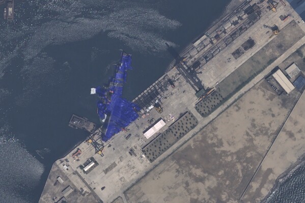 This satellite image provided by Airbus DS, shows a blue tarp covering a North Korean destroyer after it suffered a failed launch while it was being put to sea in Chongjin, North Korea, Thursday, May 22, 2025. (Airbus DS via AP)