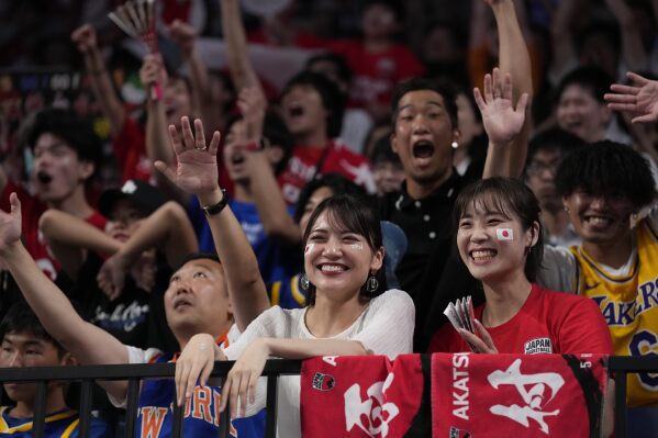 Japan's supporters cheer the team during the second half of their Basketball World Cup classification match against Cape Verde in Okinawa, southern Japan, Saturday, Sept. 2, 2023. (AP Photo/Hiro Komae)